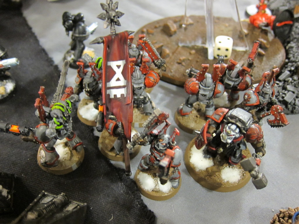 A band of Chaos Marines marches toward the Mechanicum's Strongpoint.