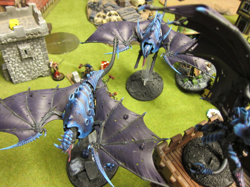 Tyranid swarm over ground defenders far below.