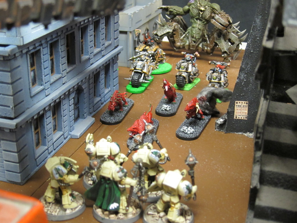 A Soul Grinder exhorts Iron Warriors and Flesh Hounds on through the alleyways toward the Dark Angels' advance.