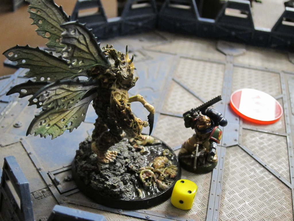 Titus battles the daemon fly to keep it from the control building.