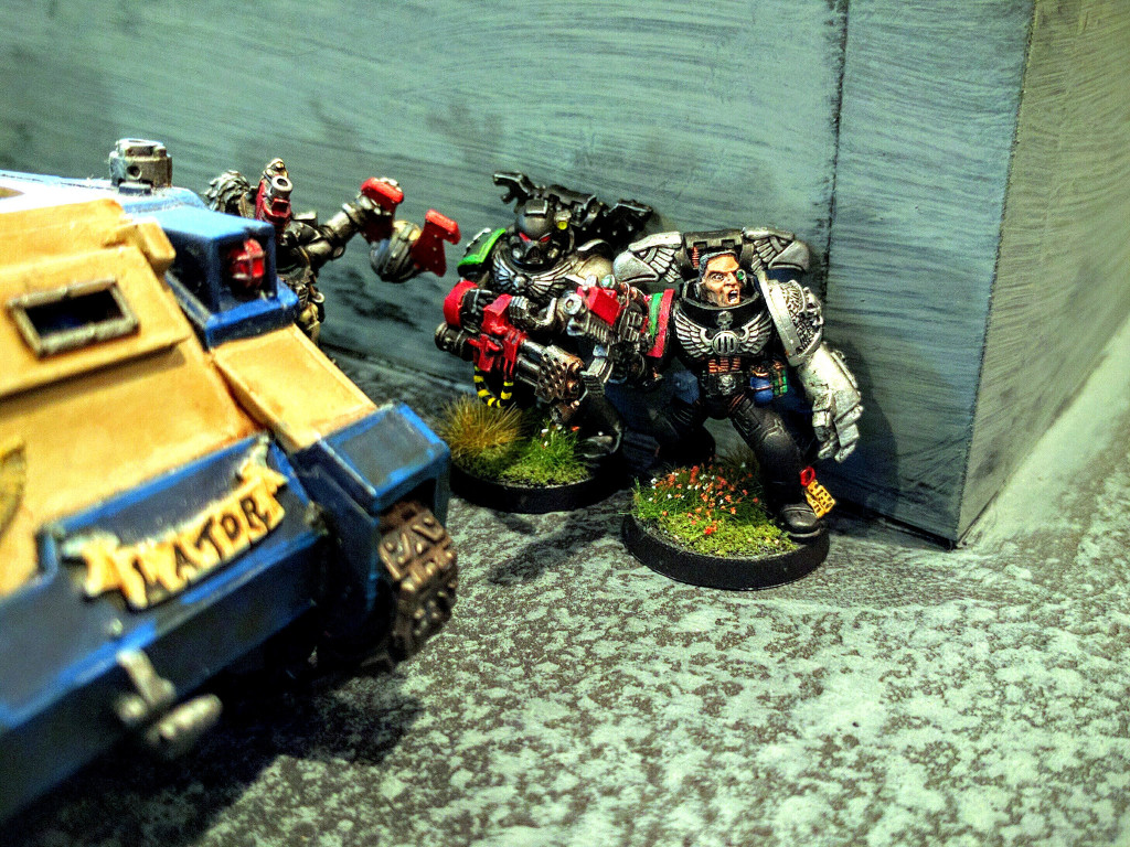 Deathwatch skulk through a complex.