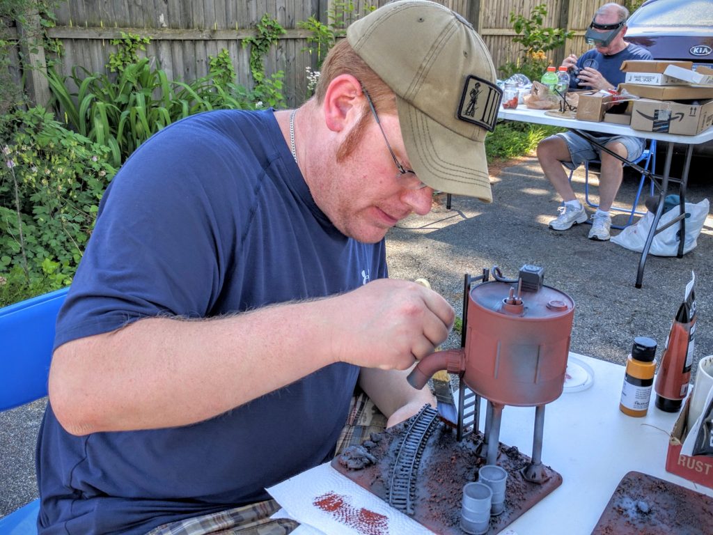 Colin drybrushing ground surfaces.